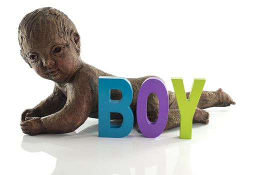 statue of crawlng baby boy made from clay isolated on white