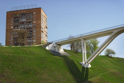 Pedestrian bridge is built of concrete across the ravine