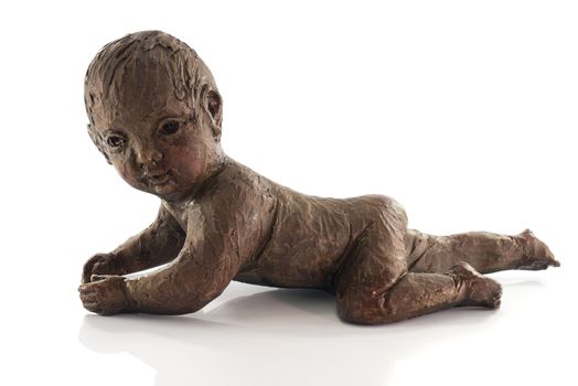 statue of crawlng baby made from clay isolated on white