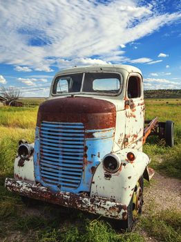 Abandon for years and old truck rusts on a farm