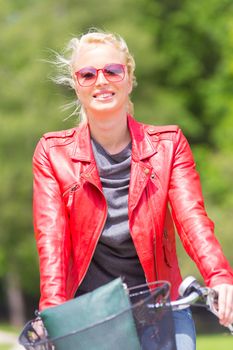 Happy young woman riding a bicycle. in the park.
