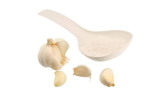 Garlic salt and spoon on a white background