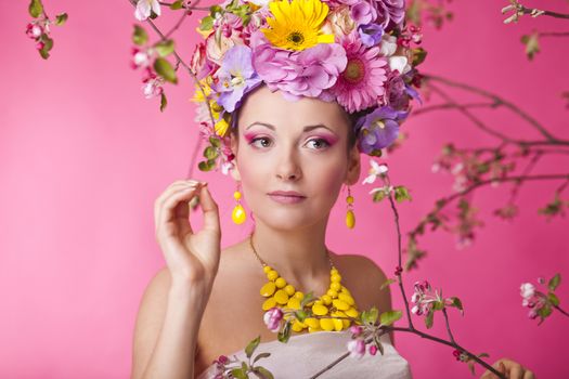 Young woman in a spring blooming apple tree garden
