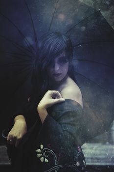 Sensual brunette woman under rain in exterior palace