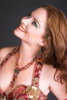 Belly Dancer wearing a red costume with jewelery