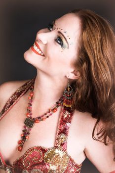 Belly Dancer wearing a red costume with jewelery