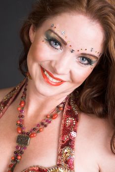 Belly Dancer wearing a red costume with jewelery