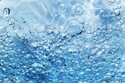 Clean fresh water with bubbles appearing when pouring water or a splash. Natural background