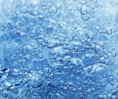 Clean fresh water with bubbles appearing when pouring water or a splash. Natural background