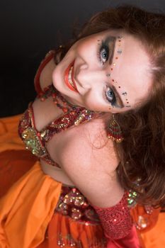 Belly Dancer wearing a red costume with jewelery