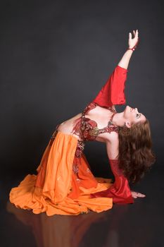 Belly Dancer wearing a red costume with jewelery