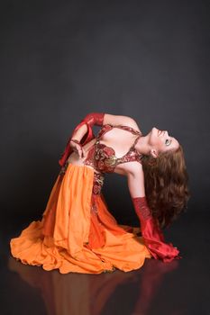 Belly Dancer wearing a red costume with jewelery