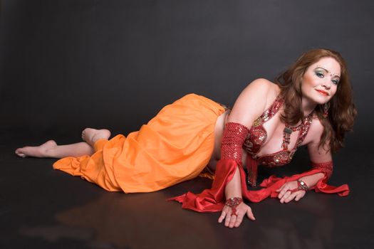 Belly Dancer wearing a red costume with jewelery