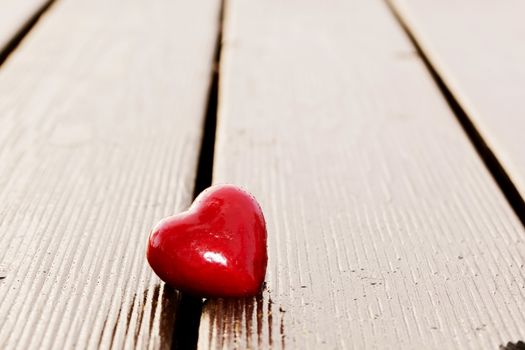 Red heart in crack of wooden plank. Symbol of love, Valentine's Day