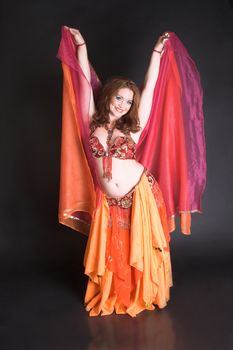 Belly Dancer wearing a red costume with jewelery