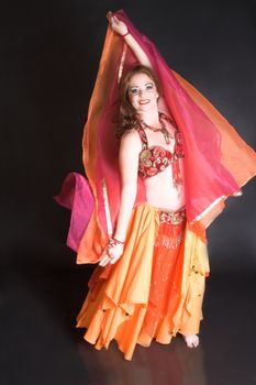 Belly Dancer wearing a red costume with jewelery