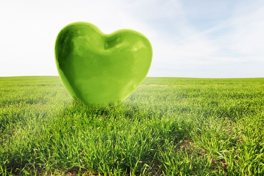 Green heart on the grassy field. Concepts of love, Valentine's Day, but also healthy environment, ecology, safe the earth