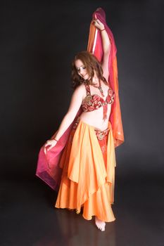 Belly Dancer wearing a red costume with jewelery