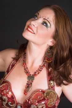 Belly Dancer wearing a red costume with jewelery