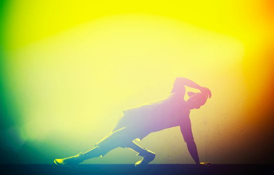 Hip hop, break dance performed by young man in colorful club lights. Breakdance party time