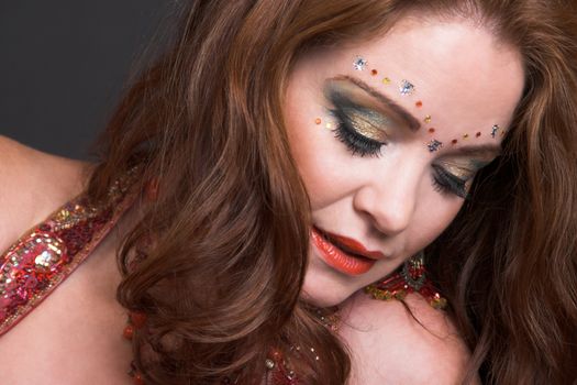 Belly Dancer wearing a red costume with jewelery