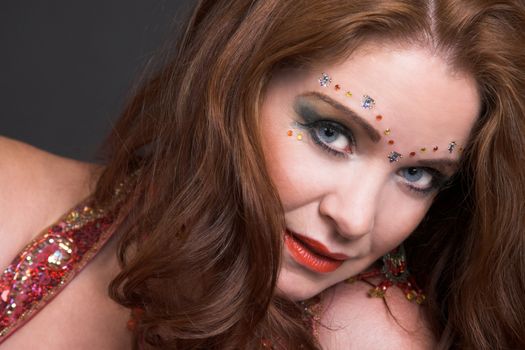 Belly Dancer wearing a red costume with jewelery