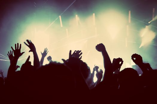 People with hands up having fun on a music concert, disco party. Vintage, retro style