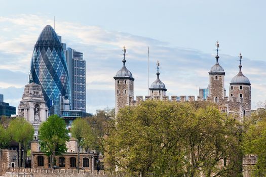 The Tower of London and the 30 St Mary Axe skyscraper aka the Gherkin, England, the UK. The historic Royal Palace and Fortress next to the financial district