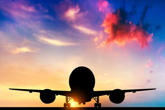 Airplane ready to take off. Silhouette of a big passenger or cargo aircraft, airline at sunset. Transportation