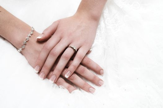 Bride and groom hands with wedding bands