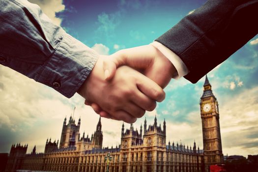 Business in London. Handshake on Big Ben, Westminster background. Deal, success, contract, cooperation concepts 