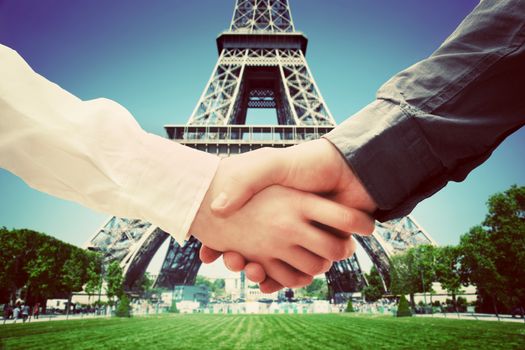 Business in Paris, France. Handshake on Eiffel Tower background. Deal, success, contract, cooperation concepts 