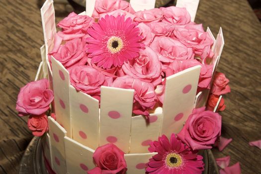 Beautiful pink and vanilla wedding cake with flowers