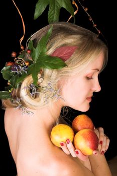 Beautiful young blond model with flowers in her hair