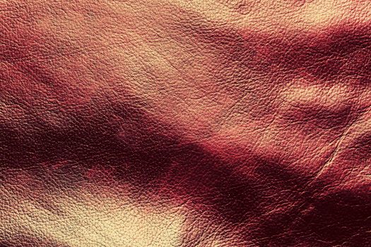 Genuine dark red leather background, pattern. High resolution photograph.