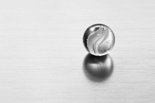 Transparent glass ball on metal surface. Conceptual modern background for sciene, technology, business etc