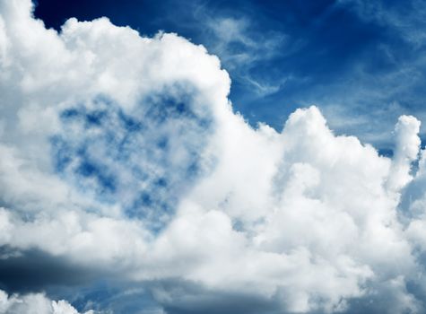 Heart shaped cloud on blue sunny sky. Love, Valentine's Day concepts