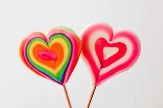 Colorful heart shaped lollipops on grey background. Love, fun, Valentine's day