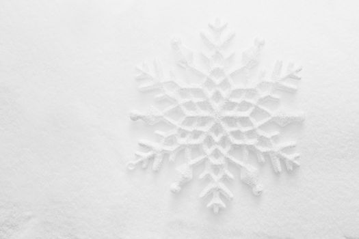 Winter, Christmas minimal elegant background. Snowflake on snow, low contrast image.