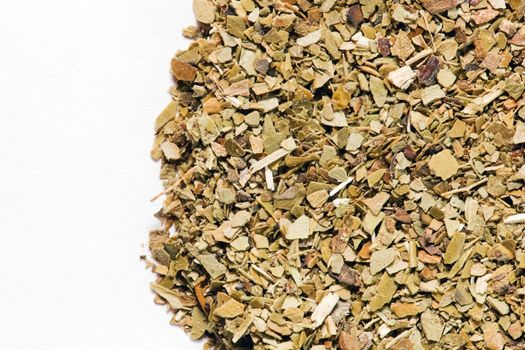 Dry Yerba Mate leaves on white background. A popular South American drink known for giving energy and being rich in vitamins.