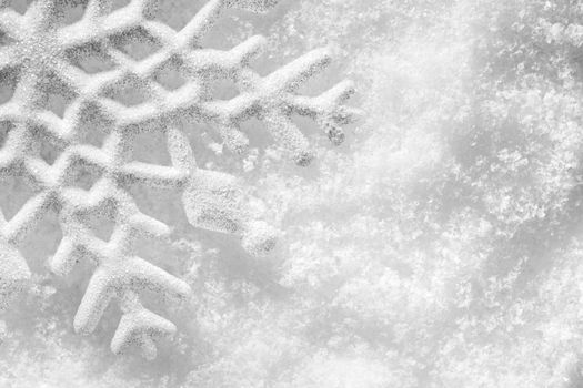 Winter, Christmas minimal elegant background. Snowflake on snow, low contrast image.