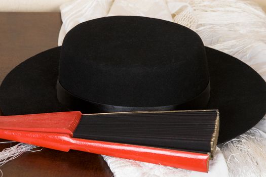 Spanish dancers fan, hat and shawl on a wooden case