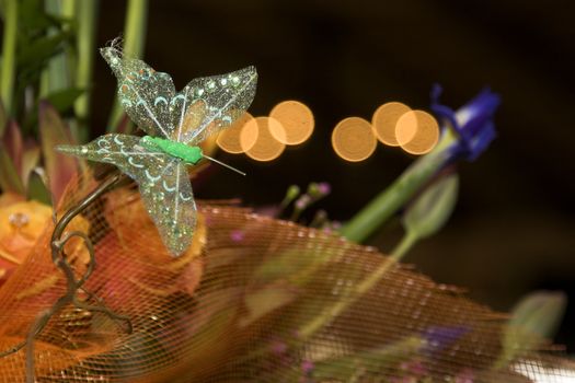 Wedding flower arrangement with green butterfly decoration