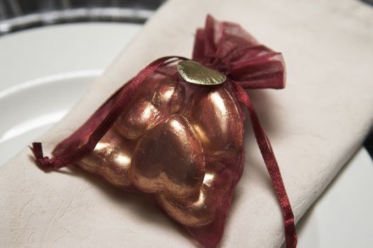 Burgundy organza bag filled with chocolate hearts