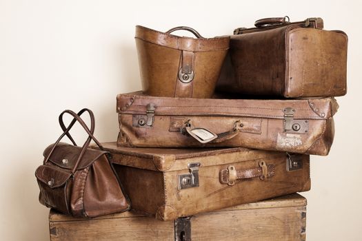Collection of leather suitcases and bags stacked