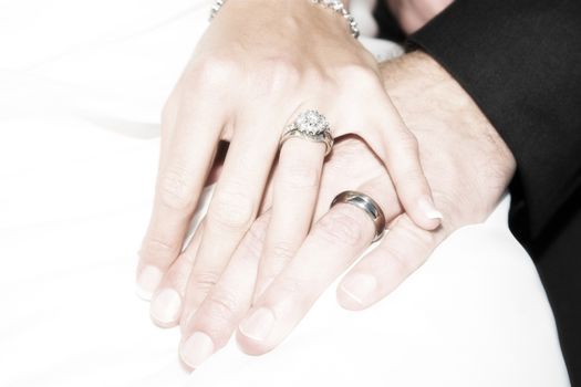 Groom holding his new bride's hand gently