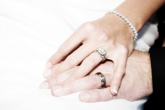 Groom holding his new bride's hand gently