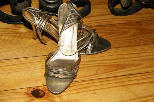 Gold Colored wedding shoes on a wooden floor