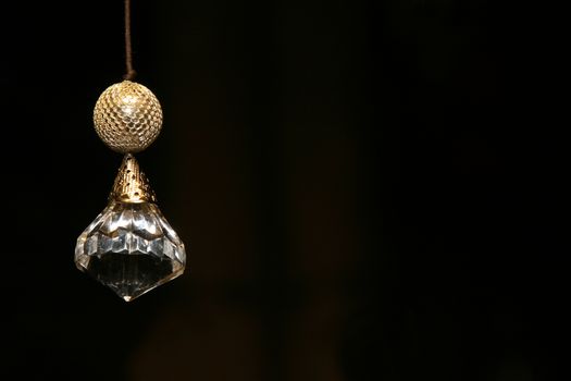 Gold decorated crystal against a black background