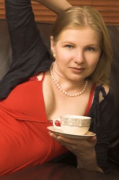 Beautiful young woman enjoying a cup of tea